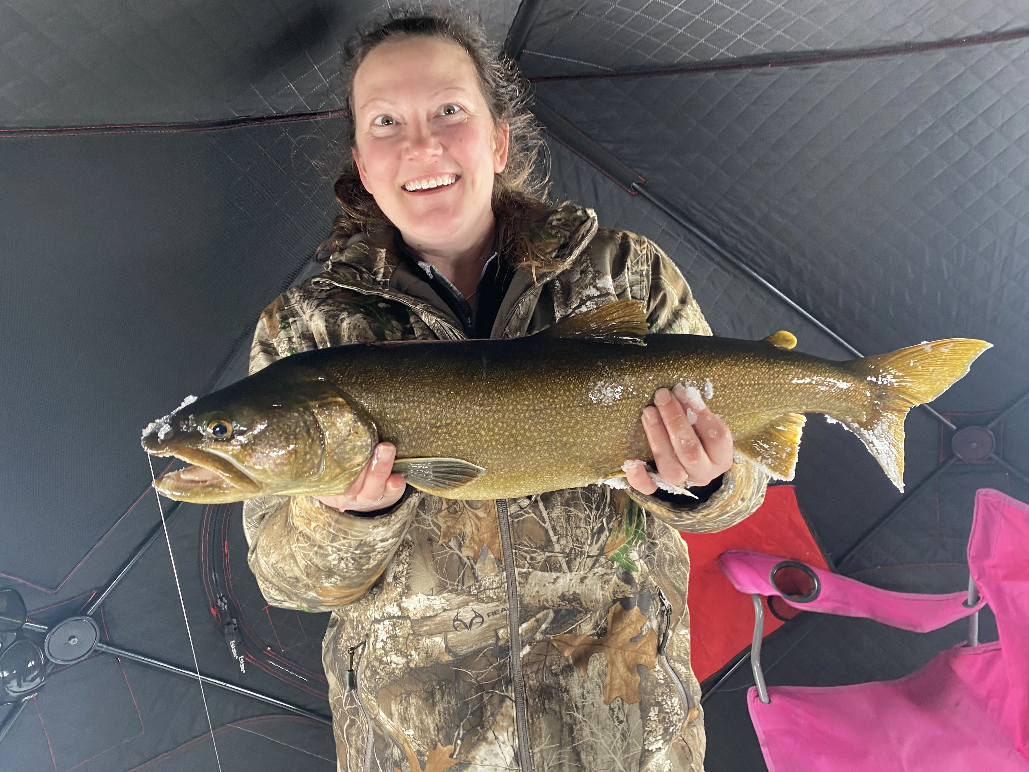 Maine fishing guide holding brook trout