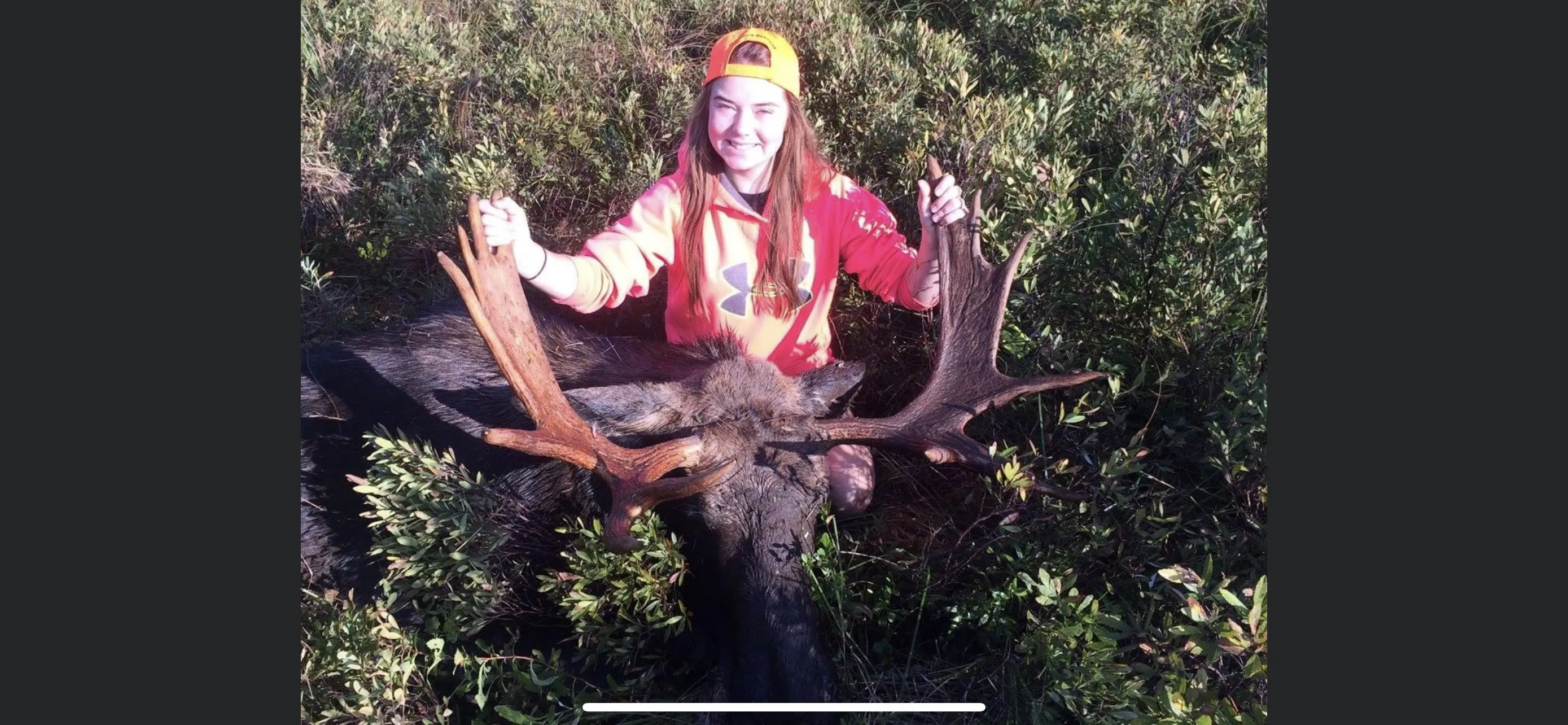 Successful female moose hunter with moose