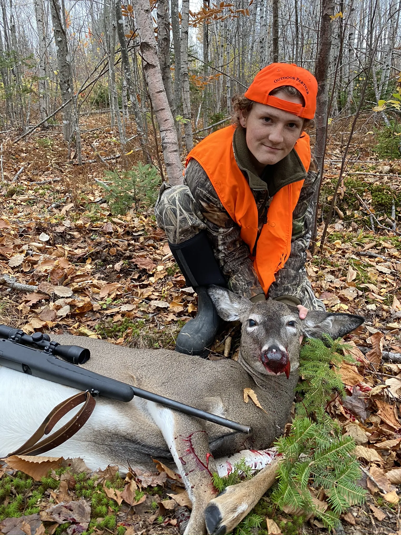 Youth hunter and doe deer